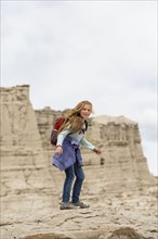 Caucasian girl standing on desert rock formations