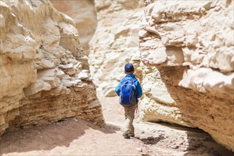 Boy exploring desert rock formations