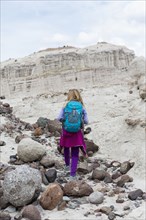 Caucasian girl exploring desert rock formations