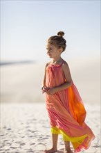 Girl standing on desert sand dune