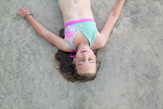 Caucasian girl napping on beach