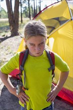 Caucasian girl frowning at campsite