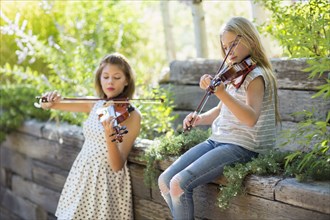 Musicians playing violins outdoors
