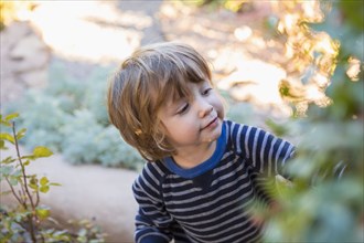 Caucasian boy playing in garden