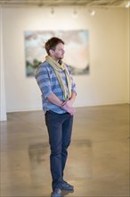 Caucasian man standing in art gallery