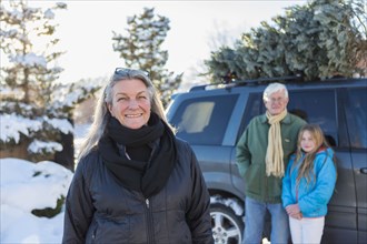Caucasian family hauling Christmas tree