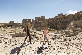 Caucasian mother and children hiking in desert