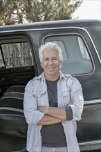 Caucasian man standing near truck with door open