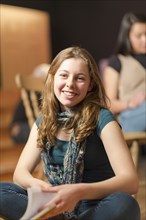 Portrait of smiling Mixed Race teenage girl in theater class