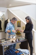 Man and woman examining jewelry in store