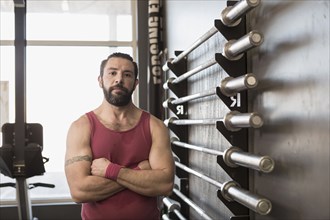 Portrait of serious Mixed Race man posing in gymnasium