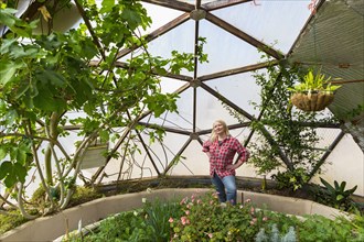 Caucasian woman posing in greenhouse