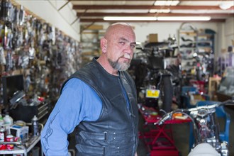 Portrait of Caucasian man repairing motorcycle