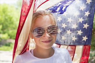 Caucasian girl wearing American flag sunglasses