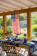 American flag hanging on patio near table