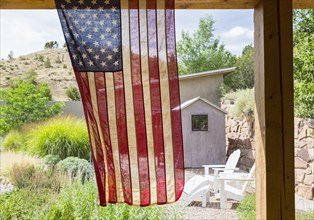 American flag hanging in backyard
