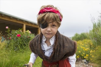 Caucasian boy wearing pirate costume