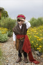 Caucasian boy wearing a pirate costume searching