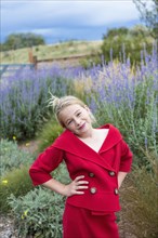 Caucasian girl wearing red dress in field