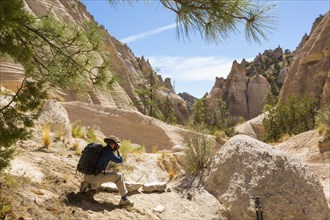 Caucasian man photographing desert landscape