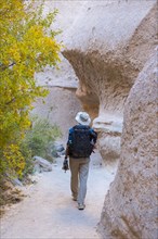 Caucasian man hiking near boulders