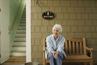 Senior woman smiling on the porch