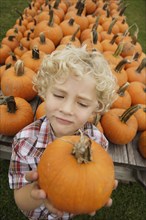 Portrait of boy holding pumpkin