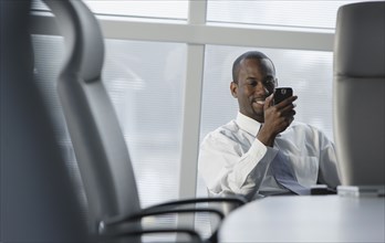 African American businessman looking at cell phone