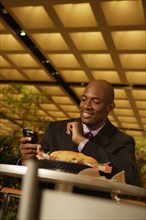African businessman looking at cell phone