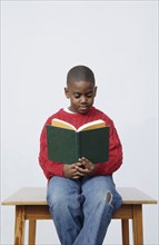 African boy reading book