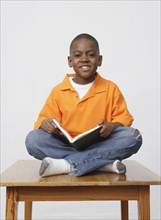 African boy holding book