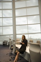 African businesswoman talking on cell phone in conference room