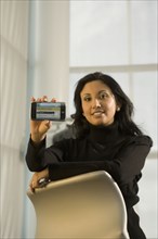 Hispanic businesswoman holding cell phone