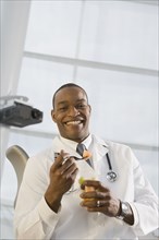 African doctor eating fruit
