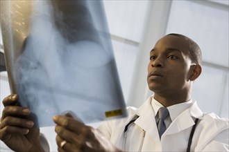 African doctor reviewing x-ray