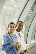 Doctor and nurse holding fruit