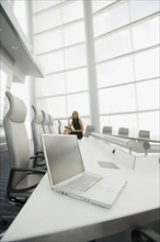 African businesswoman and laptop in conference room