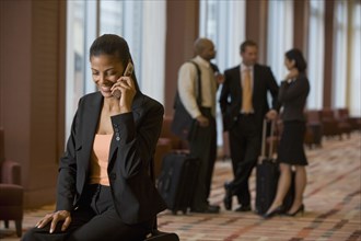 African businesswoman talking on cell phone