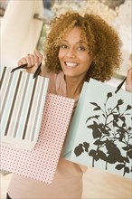 Mixed race woman holding shopping bags