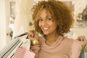 Mixed race woman holding shopping bags