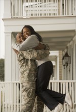 African soldier hugging girlfriend