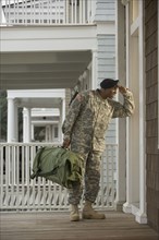 African soldier standing on front stoop