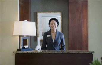 African woman at concierge desk