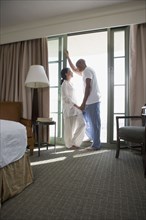 African couple in pajamas holding hands