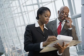 African businesspeople reviewing paperwork
