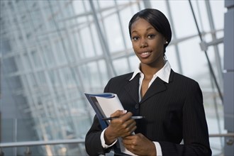 African businesswoman holding paperwork