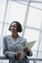 African businesswoman holding paperwork