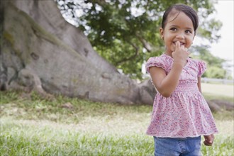 Hispanic preschool girl standing outdoors