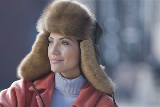 Hispanic woman wearing fur hat
