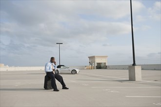 African businessman waiting in parking lot